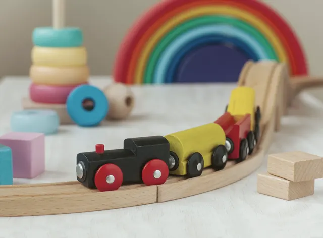 Wooden toys and a rainbow in a playroom
